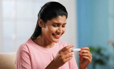 A woman celebrates a positive pregnancy test after exploring natural Pregnancy Booster Plan